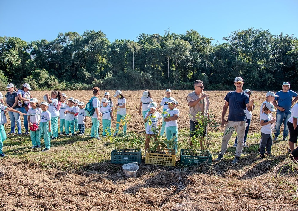 Local children help with reforestation efforts, photo courtesy of partner AMLD